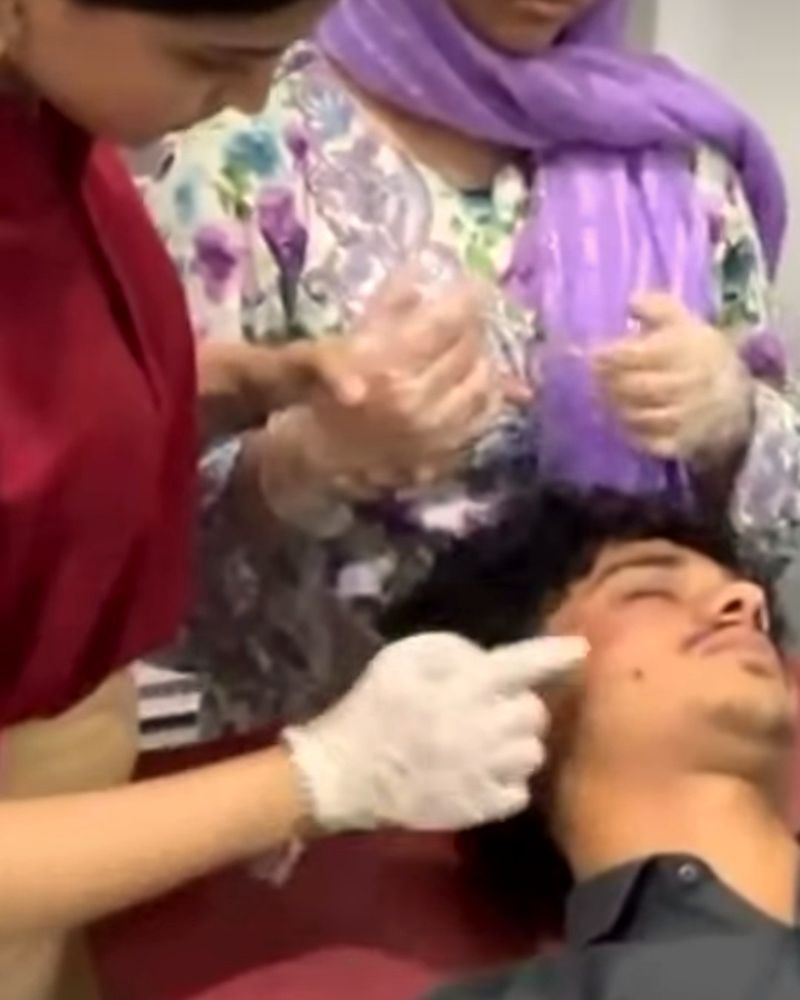 A hands-on facial procedure on a male model during the aesthetics workshop