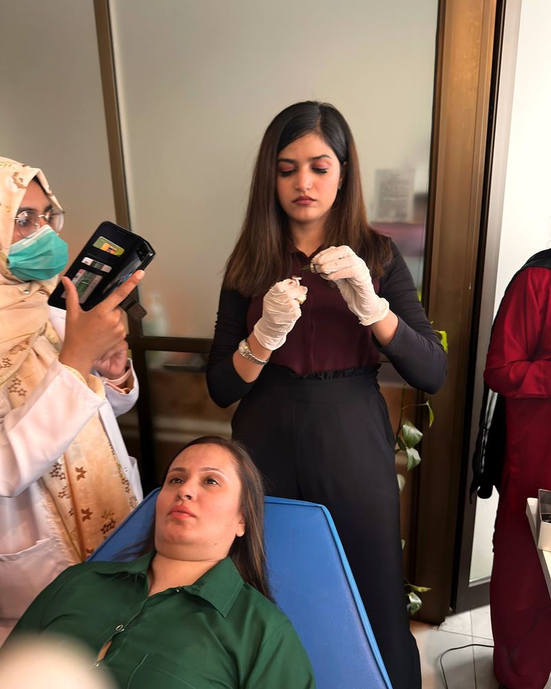 Mehak Ishtiaq with a model and an assistant during a live demonstration