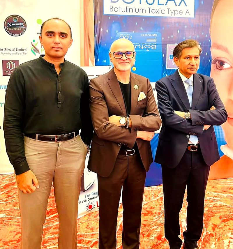Three men posing together at an event at Pearl-Continental Hotel Lahore