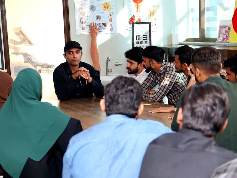 Participants seated around a table in a small-group teaching session on neonatal ventilation